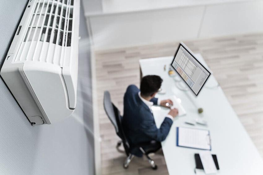 Air purifier above a desk in an office